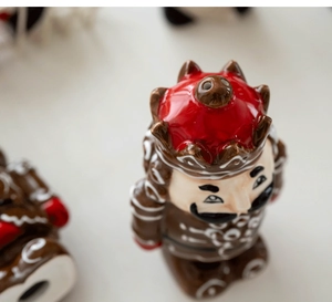 Detail of a gingerbread man ceramic seasoning jar with a festive red crown lid and holes