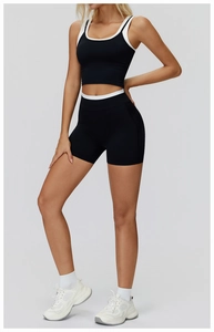 Close-up of black and white yoga set featuring ribbed high waist shorts and sport bra