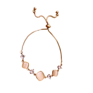 Gold adjustable bracelet featuring square faux cat-eye stones and cubic zirconia accents
