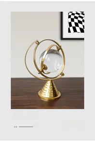 Detail of crystal ball on golden metal rings with hammered brass cone base