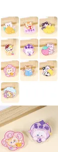 Close-up detail of clear acrylic cat brooches with colorful feline illustrations and charms