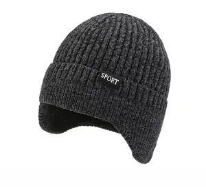 Detail view of dark grey knitted beanie with ribbed texture and SPORT label for winter
