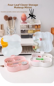 Detail view of pink clover makeup box with compartments for jewelry and a built-in mirror