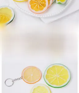 Detailed view of yellow, orange and green PVC artificial lemon slices with keychains
