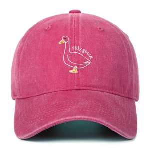 Close-up of the silly goose embroidery on a vintage washed pink cotton baseball cap