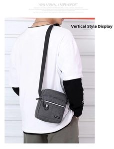Vertical grey oxford shoulder bag for men featuring reflective zipper and adjustable strap