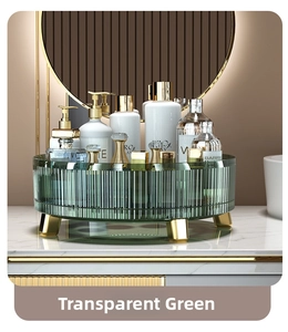 Macro shot of green rotating makeup organizer with gold feet on marble surface
