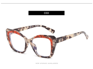 Detail of tortoise shell TR90 square frame with red floral accents and blue light lenses