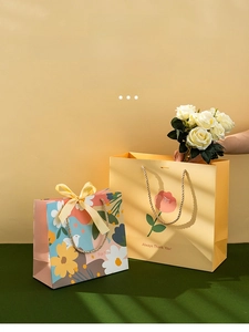 Detailed view of premium floral gift bags with thick cardstock and satin ribbon bows