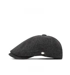 Close-up of dark grey wool newsboy cap featuring detailed texture and metal side logo