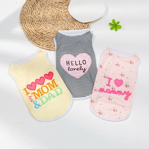 Three cute summer dog vests with heart patterns and cartoon prints on a fresh background