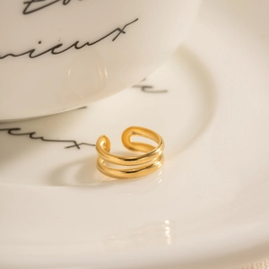 Elegant 18k gold plated double layer open ring for women on a white ceramic background