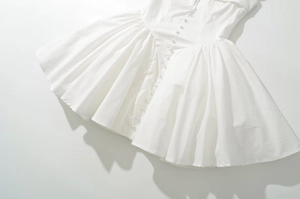 Detailed top-down view of white puff dress with square neck and button front details