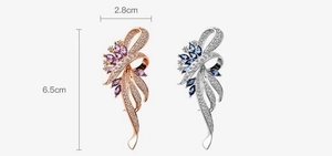 Detailed view of elegant bauhinia flower brooches with purple and blue crystals