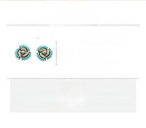 Detail of vintage acrylic flower earrings with blue beads and rhinestone accents