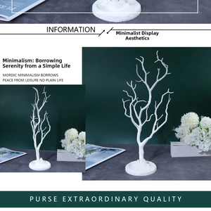 Detailed view of white branch tree stand for hanging necklaces and earrings jewelry