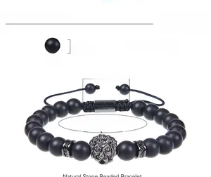 Detail of adjustable black matte stone beaded bracelet with silver lion head charm