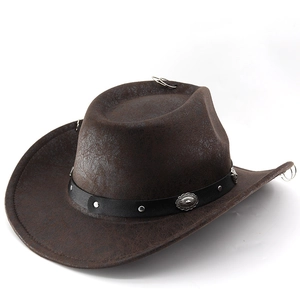 Detail of dark brown vintage cowboy hat featuring silver studs and metallic ring accents