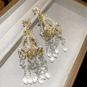 Macro detail of vintage gold crystal earrings with pearls and chandelier tassels