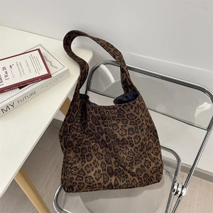 Macro shot of faux suede leopard print pattern and interior lining on a large tote bag