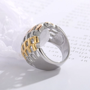 Detailed close-up of two-tone stainless steel ring with woven mesh hollow pattern