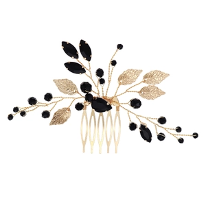 Handmade bridal hair comb with gold metal leaves and faceted black beads for wedding styling