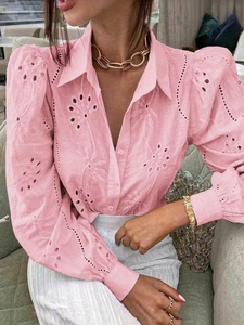 Detailed view of hollow-out floral embroidery on pink puff sleeves casual blouse