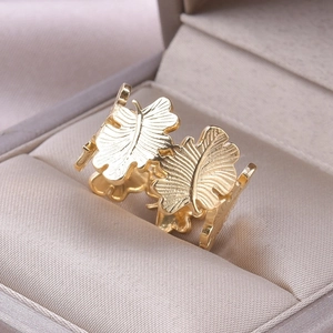 Macro shot of gold leaf-shaped ring texture in a soft velvet jewelry gift box