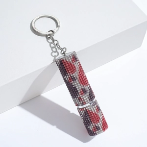 Detailed view of lipstick-shaped keychain with red and purple rhinestones