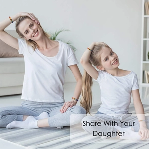 Matching 7 chakra beaded bracelets worn by mother and daughter during yoga exercises