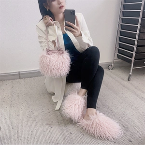 Pink faux sheepskin plush bucket bag and matching slippers in a cozy lifestyle setting