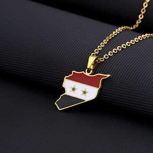 Macro detail of Syrian map pendant necklace with national flag enamel inlay on gold chain