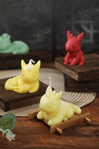 Close-up of handmade dragon scented candles on a wooden tray for home decor