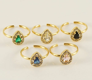 Detailed view of teardrop zircon rings set in gold plating with five vibrant colors