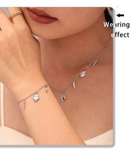 Detail showing wearing effect of silver heart pendant necklace and matching bracelet set