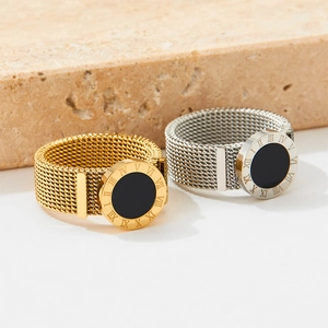 Braided stainless steel mesh rings in gold and silver with Roman numeral disc accents