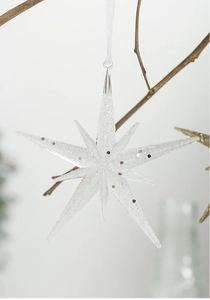 Close-up of white glitter star ornament with a textured finish for Christmas tree decor