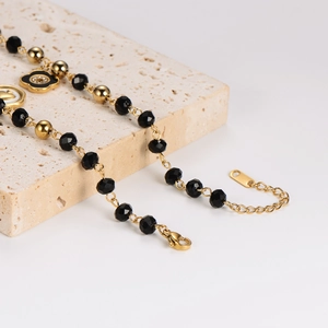 Fashionable gold flower pendant bracelet with black faceted beads and lobster clasp