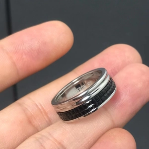 Detail view of silver ring with black square pattern and ERON 57 inner engraving