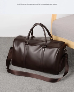 Detail of dark brown lychee grain PU leather sports bag with side zipper and handle