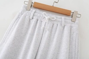 Detailed close-up of gray knit jogger waist with elastic band and drawstring