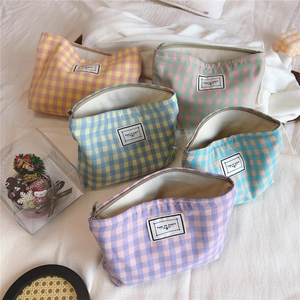Close-up of pastel plaid canvas makeup bags with zipper and Time To Party label
