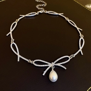 Silver bow choker necklace with sparkling rhinestones and a central pearl drop charm