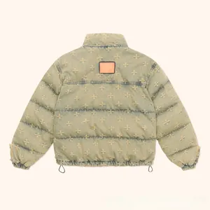 Detail showing vintage denim puffer jacket with floral embroidery and back leather patch