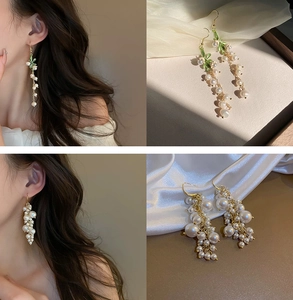 Detailed view of lily of the valley and grape-shaped gold pearl tassel earrings