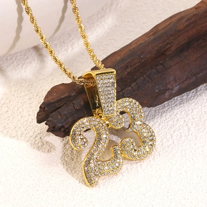 Detailed shot of golden number 23 pendant with white zircons on a rope chain
