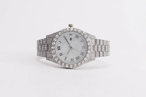 Detailed macro view of luxury silver women's watch with full crystal pavé and Roman numerals