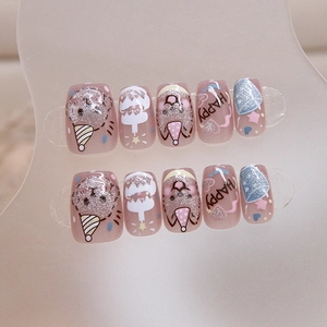 Cat eye press-on nails with cute cartoon puppy and birthday cake designs in pink beige