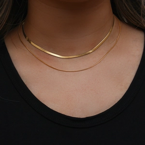 Close-up of double layered 18K gold plated herringbone and snake chains on neck