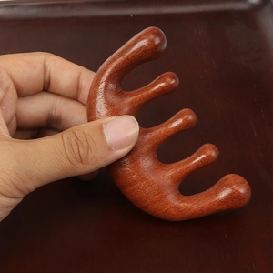 Handcrafted red sandalwood five-tooth scalp massage comb with natural wood grain
